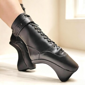 May include: A black ankle boot featuring a lace-up front with metal eyelets and a smooth, matte finish. The boot has a distinct, curved, structural heel design that elevates the foot, creating a unique silhouette with a wrap-around ankle strap.