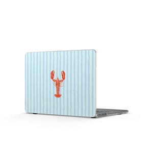 May include: A laptop computer featuring a protective skin with a light blue and white vertical striped pattern. Centered on the lid is a detailed illustration of a bright orange lobster, positioned vertically with its claws pointing upward.