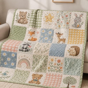 May include: A quilted blanket featuring a patchwork design of woodland animals including a bear, fox, raccoon, deer, and hedgehog, alongside motifs of a rainbow, star, flowers, and trees in soft shades of green, blue, orange, and cream.