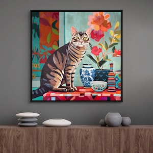 May include: A framed artwork featuring a tabby cat sitting on a patterned surface. The cat is surrounded by vases, bowls, and flowers. The background includes colorful floral and abstract patterns. The artwork is displayed on a wooden cabinet.