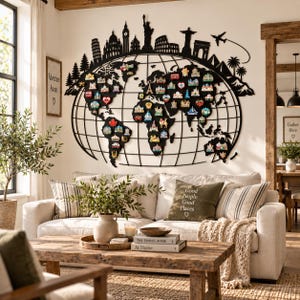 May include: A large black metal world map wall art piece featuring a grid of longitudinal and latitudinal lines. The top edge displays a silhouette of global landmarks and an airplane. Small colorful souvenir magnets are attached to the continents.