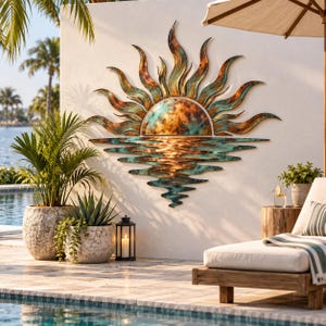 May include: A large metal wall art piece depicting a sun rising over water. The design features a semi-circular sun with radiating flame-like rays and a rippling water reflection below, finished in a weathered patina of copper, bronze, and teal.