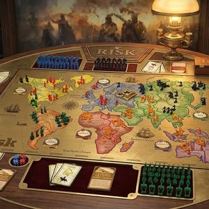May include: A Risk board game set on a circular wooden table featuring a world map game board with colored plastic army figures, decks of cards, and dice. The board displays the Risk logo, various continents, and ocean labels in a vintage style.