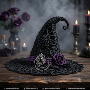 May include: A black crocheted witch hat featuring a pointed, curved top and a wide brim with a spiderweb pattern. The hat is adorned with a purple band, a silver-toned oval brooch with a black center stone, a silver chain, and a purple fabric rose.