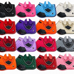 May include: A collection of twenty-four quilted horse saddle pads in various solid colours, each featuring a matching pair of ear bonnets, a black triangular patch, and a black reinforced girth area with white stitching details.