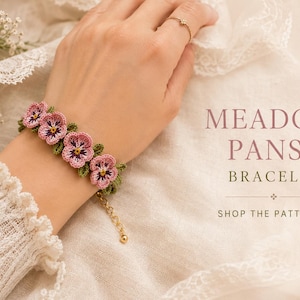 May include: A crochet bracelet featuring pink and purple pansy flowers with green leaves, connected by a gold-toned metal chain with a clasp. The text MEADOW PANSY BRACELET and SHOP THE PATTERN is visible on the right side of the image.