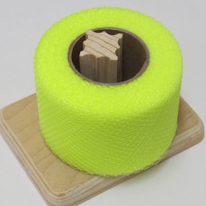 May include: A roll of bright yellow netting on a wooden spool. The netting is a fine mesh and is likely used for crafts or decoration.