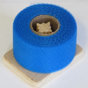 May include: A roll of bright blue netting on a wooden spool. The netting is a fine mesh and is ideal for crafts or packaging.
