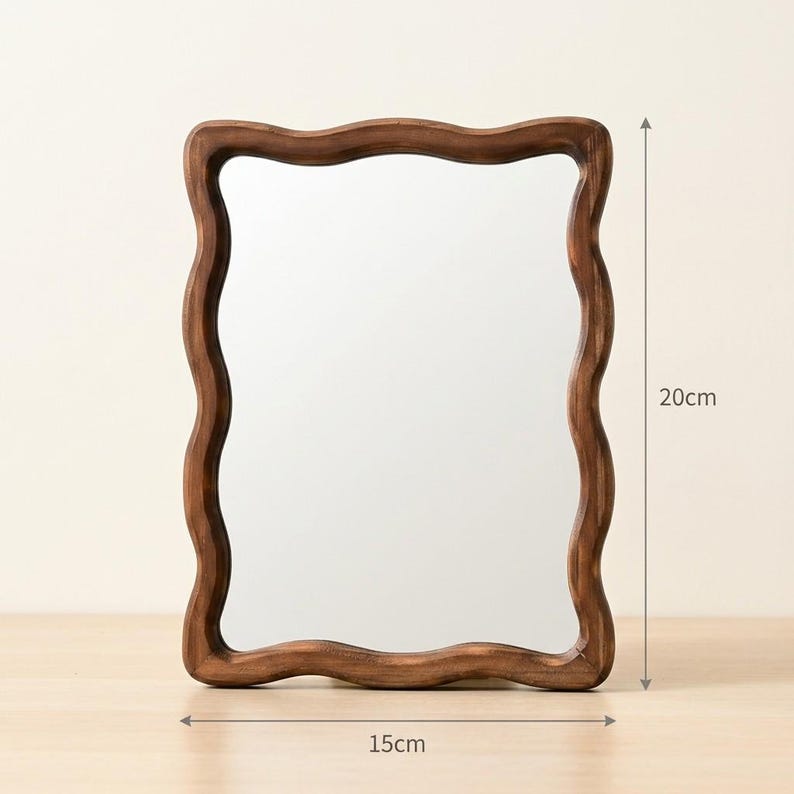 Wavy wood framed mirror size guide, 20 cm tall by 15 cm wide, small organic tabletop mirror with natural brown finish.