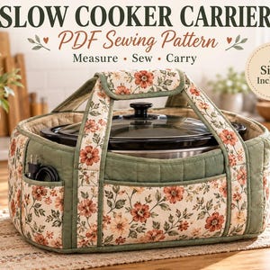 May include: A quilted fabric slow cooker carrier featuring a floral pattern with red and orange flowers on a cream background, accented by sage green panels. The carrier includes sturdy handles, exterior pockets, and a black slow cooker inside.