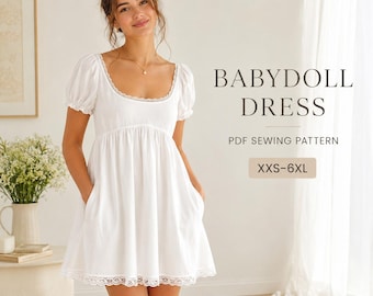 May include: A white babydoll dress with short puff sleeves, a scoop neckline, and lace trim along the collar and hem. The dress features a gathered waist and side pockets. Text on the image reads: BABYDOLL DRESS, PDF SEWING PATTERN, XXS-6XL.