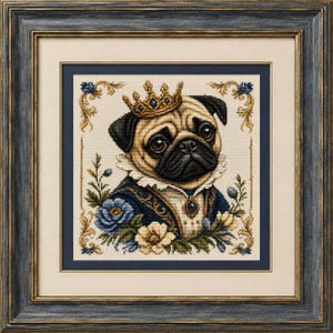 May include: A framed cross-stitch embroidery featuring a tan pug wearing a gold crown with blue gems and a dark blue jacket with a white ruffled collar. The pug is surrounded by blue and cream flowers and gold filigree accents in a dark frame.