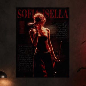 May include: A rectangular wall poster featuring the text SOFI ISELLA in red capital letters at the top. The image depicts a performer holding a microphone and a violin bow, illuminated by red light against a dark background with handwritten text.