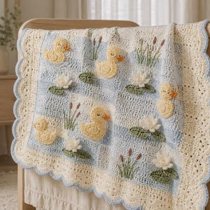 May include: A crocheted baby blanket featuring a grid pattern of light blue and cream squares. The blanket is decorated with appliqued yellow ducks, white water lilies with green leaves, and brown cattails, finished with a scalloped cream border.