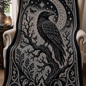 May include: A black and grey crocheted blanket featuring a detailed raven perched on a tree branch. The design includes a large crescent moon, scattered stars, and small butterflies, all framed by an intricate, ornate botanical border pattern.