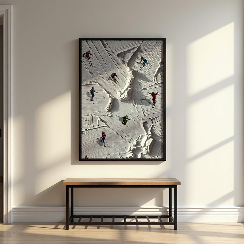 May include: A rectangular framed wall art piece featuring a textured white impasto surface depicting a snowy mountain slope with several small figures of skiers in colorful outfits, including red, blue, green, and orange, navigating the terrain.