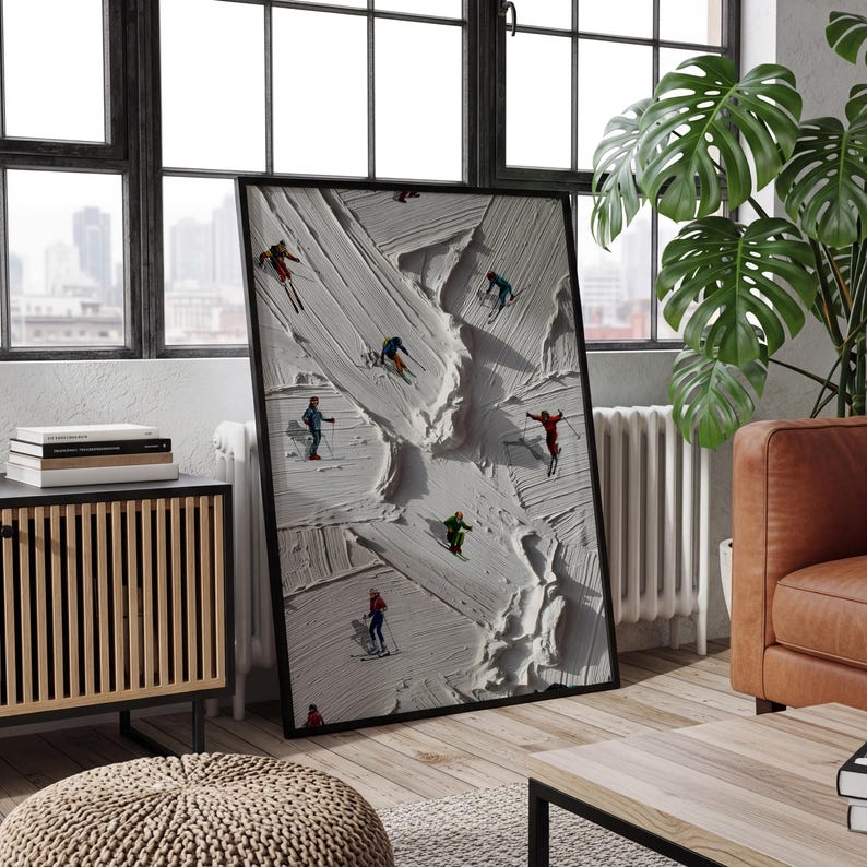 May include: A framed vertical wall art piece featuring a textured white impasto background that mimics snow, with several small figures of skiers in colorful outfits positioned across the surface, each equipped with skis and poles in a winter scene.