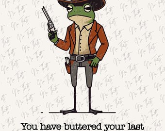 May include: A green frog character wearing a brown cowboy hat, a tan shirt, and a brown jacket with a holster. The frog holds a revolver and stands above the black text: You have buttered your last biscuit, partner. The background has a repeating watermark.