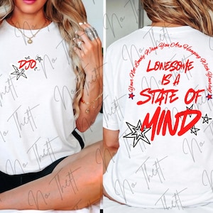 May include: A white t-shirt featuring a small red and black star graphic with the text DJO on the front. The back displays the red text LONESOME IS A STATE OF MIND, surrounded by a curved phrase and black and red star illustrations.