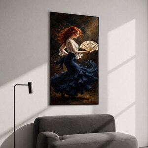 May include: A framed wall art print depicting a person with long red hair wearing a white lace long-sleeve top and a dark blue ruffled skirt. The figure is captured in motion, holding a beige folding fan against a dark, textured background.