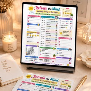 Puede incluir: Una tableta digital y una hoja impresa que muestran una plantilla de planificador diario Refresh the Mind. El diseño incluye secciones para la intención de hoy, el plan diario, reinicio rápido, control de atención plena y reflexión nocturna.