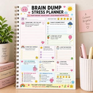 May include: A spiral-bound Brain Dump Stress Planner with a white cover featuring colourful illustrations of a brain, sun, clouds, and hearts. The page includes sections for brain dumping, stress causes, priorities, self-care, and daily check-in scales.