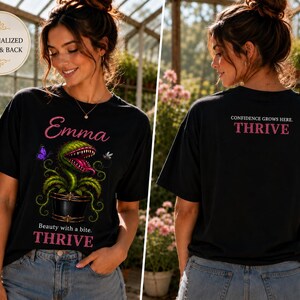 May include: A black t-shirt featuring a graphic of a green carnivorous plant in a pot with the name Emma, the text Beauty with a bite, and THRIVE on the front. The back displays the text CONFIDENCE GROWS HERE and THRIVE in pink lettering.