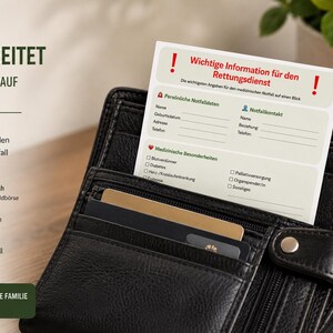 May include: A black leather wallet containing a white emergency medical information card. The card features red exclamation marks and German text including sections for personal data, emergency contacts, and medical conditions with checkboxes.