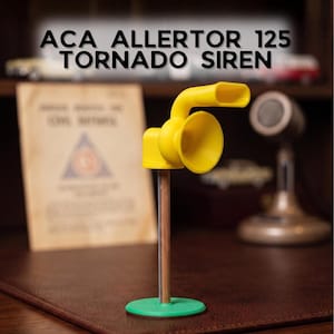 May include: A yellow ACA ALLERTOR 125 TORNADO SIREN model featuring a horn-shaped speaker and a curved exhaust pipe mounted on a vertical brown pole with a circular green base. The text ACA ALLERTOR 125 TORNADO SIREN is displayed above the object.