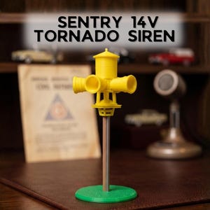 May include: A yellow Sentry 14V Tornado Siren model featuring a central cylindrical housing with four protruding horn speakers, mounted on a vertical wooden pole attached to a circular green base. The text SENTRY 14V TORNADO SIREN is visible.