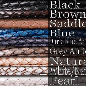 A display of leather necklaces labeled with colors. Black, brown, saddle, blue, dark blue antique, grey antique, natural, white/natural and pearl.