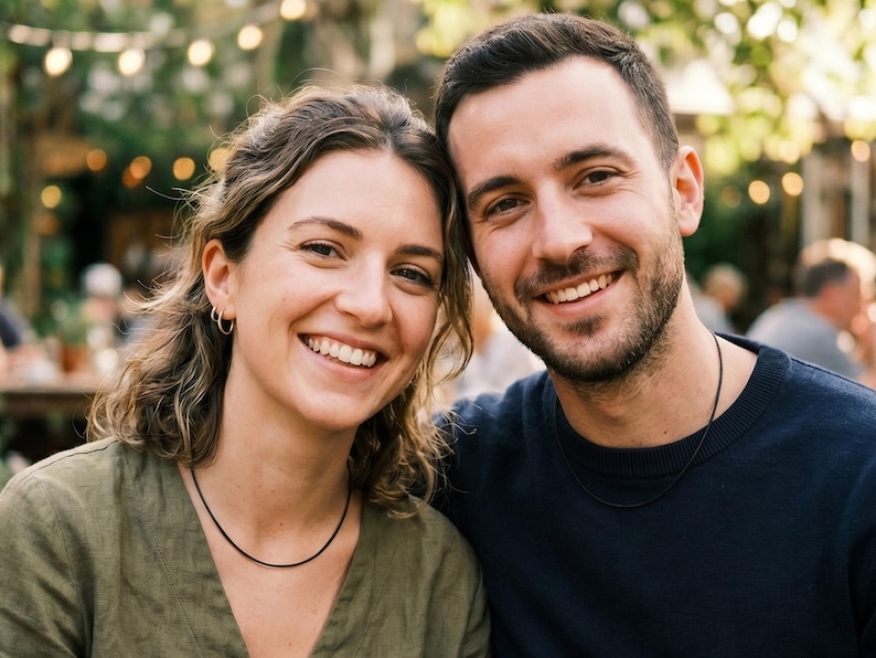 A lifestyle image of a male and female wearing a 2mm black leather necklace.