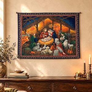 May include: A rectangular wall tapestry featuring a detailed nativity scene with a central manger, figures of Mary, Joseph, and the infant Jesus, surrounded by various animals including sheep, a donkey, and an ox, all set within a rustic wooden stable.
