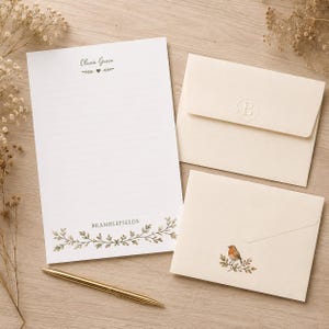 May include: A white lined stationery sheet with the name Olivia Grace and a heart icon at the top, and the text BRAMBLEFIELDS with a green leaf border at the bottom. Two cream envelopes are included, one with a letter B seal and one with a robin.