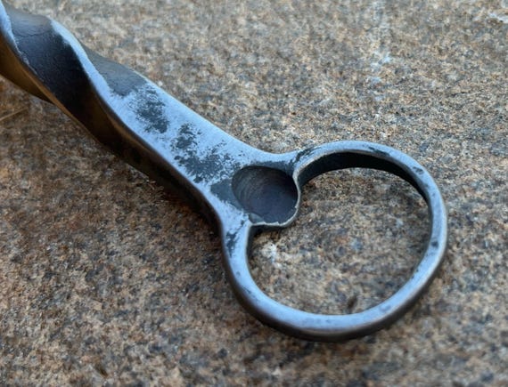 Individually hammer-forged steel with a visible twist — you can see the blacksmith's work in every bar of the metal.