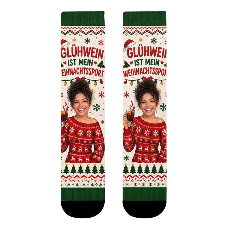 May include: A pair of crew socks featuring a cream background with a red and green holiday pattern. The design includes the text GL&Uuml;HWEIN IST MEIN WEIHNACHTSSPORT, snowflakes, and a photographic print of a person wearing a red patterned sweater.