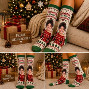 May include: A pair of cream-colored socks featuring a green cuff and toe, decorated with a red and green holiday pattern, a photo of a person, and the text GL&Uuml;HWEIN IST MEIN WEIHNACHTSSPORT printed in red and green lettering on the upper section.