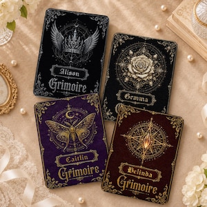 May include: Four rectangular books with ornate covers. The black book labeled Alison features a crown and wings. The black book labeled Gemma shows a rose. The purple book labeled Caitlin displays a moth. The dark red book labeled Belinda shows a compass.