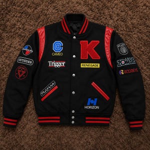 May include: A black varsity jacket with red leather sleeves and striped ribbed trim. The front features a large red letter K, various embroidered patches including Cameo, Trigger, Renegade, Plasma, Horizon, Outsider, Vigilante, Zombie, and Goddeye.
