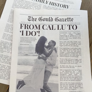 May include: A custom newspaper print titled The Gould Gazette featuring the headline FROM CAL LU TO I DO! and a black and white photograph of a couple embracing on a beach. The layout includes columns of text, a marriage metrics timeline, and a header.