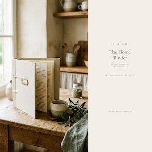 May include: A beige fabric-covered binder with a brass label holder on the spine, containing pages with handwritten text. The binder is open on a wooden surface next to a ceramic cup, a small glass jar, and a green cloth, with text on the right.