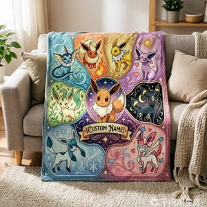 May include: A rectangular fleece blanket featuring a central illustration of Eevee surrounded by its various evolutions including Vaporeon, Flareon, Jolteon, Espeon, Umbreon, Leafeon, Glaceon, and Sylveon. A banner at the bottom contains the text CUSTOM NAME.