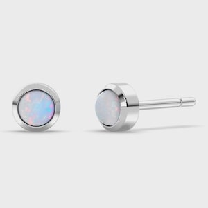 May include: A pair of stud earrings featuring round, iridescent opals set in polished silver-toned metal. One earring is shown from the front, while the other is displayed from the side, revealing the straight post and the smooth, circular bezel setting.