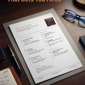 May include: A printed construction resume for Marcus Wells featuring sections for work experience, education, and core skills. The document includes a small circular image of construction tools, a black pen, and blue-rimmed glasses nearby.