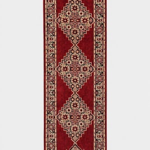 May include: A rectangular runner rug featuring a deep red field with three central diamond-shaped medallions in black, cream, and red. The border displays intricate floral and geometric patterns in matching colors, finished with short fringe at both ends.