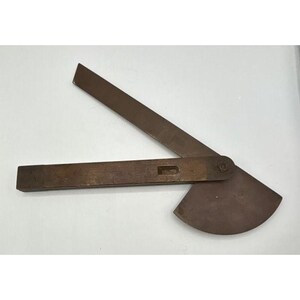 May include: A brown metal protractor tool featuring a straight arm and a pivoting semi-circular base. The device includes a rectangular cutout on the main arm and a central pivot point that allows the two components to adjust at various angles.
