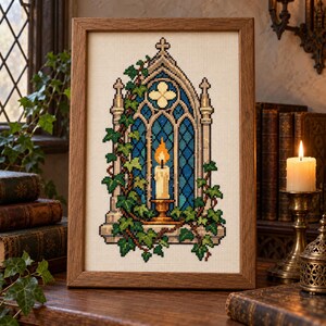 May include: A framed cross-stitch embroidery depicting a gothic stone archway with blue stained glass, a lit candle in a gold holder, and green ivy vines climbing the structure, all set against a cream-colored fabric background.