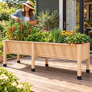 May include: A rectangular wooden raised garden bed with diagonal slat paneling and four sturdy legs featuring black protective feet. The planter is filled with various plants, including tomato vines with red fruit, green herbs, and flowering plants.