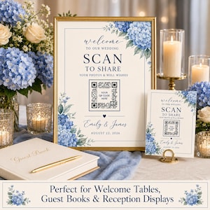 May include: A wedding welcome sign and a smaller matching card featuring blue hydrangea floral illustrations, the text "WELCOME TO OUR WEDDING SCAN TO SHARE YOUR PHOTOS & WELL WISHES", a QR code, the names "Emily & James", and the date "AUGUST 22, 2026".