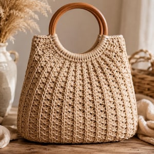 May include: A beige crochet handbag featuring a textured, ribbed pattern throughout the body and a circular, polished wooden handle. The bag has a structured, tapered shape with a reinforced opening where the handle attaches to the woven material.